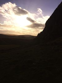 Scenic view of landscape against cloudy sky