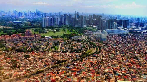 High angle view of modern buildings in city against sky