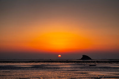 Scenic view of sea against romantic sky at sunset