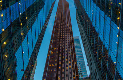 Low angle view of illuminated modern buildings in city