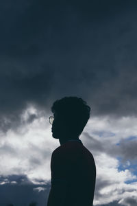 Silhouette man standing against sky