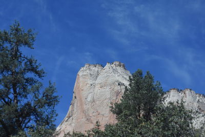 Low angle view of mountain against blue sky