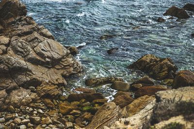 High angle view of rocks in sea