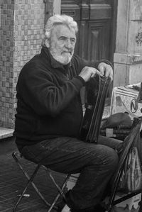 Portrait of man sitting on chair