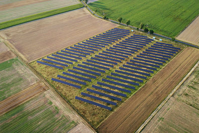 Solar energy production using solar battery panels in field, view from above