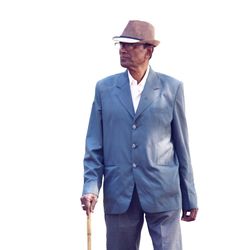 Senior man wearing hat standing against white background