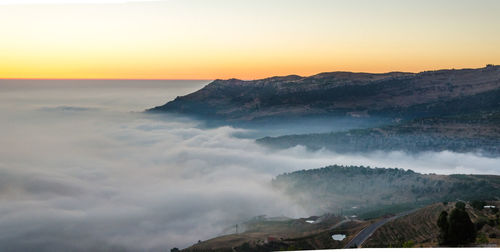 Scenic view of mountains against sky during sunset