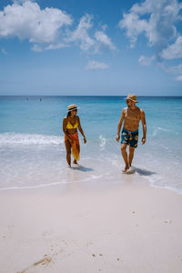 People on beach against sky