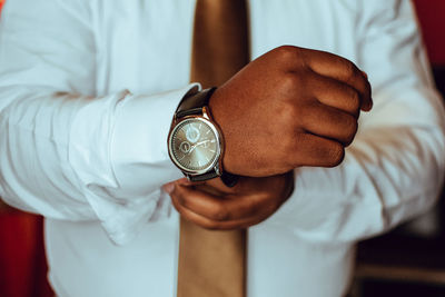 Midsection of businessman wearing watch