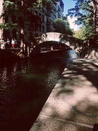 Canal amidst trees in city