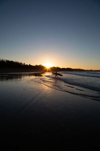 Scenic view of beach against sky during sunset