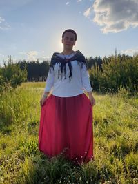 Portrait of woman standing on field