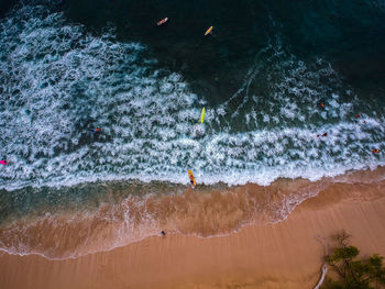 High angle view of people enjoying in sea