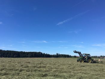 Scenic view of landscape against blue sky