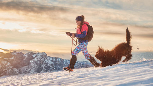 Full length of woman on snow covered land against sky