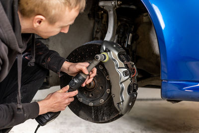 Close-up of man repairing car