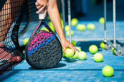 Low section of woman playing with ball