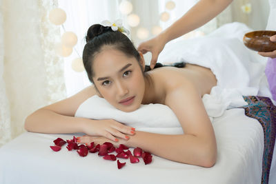 Young woman receiving lastone therapy in spa