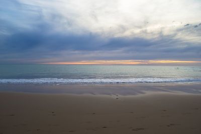 Scenic view of beach against sky during sunset