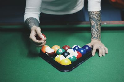 Cropped image of man holding multi colored hair