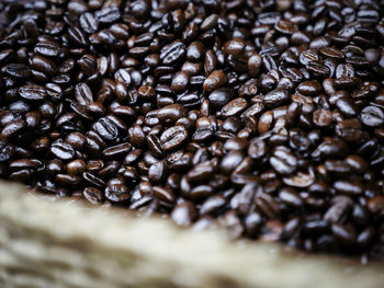 Close-up of roasted coffee beans in wicker basket in store