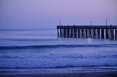 Silhouette of pier on sea