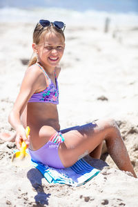 Portrait of young woman in bikini at beach