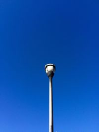 Low angle view of street light against clear blue sky