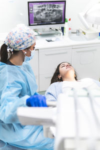 Dentist examining patient in dental clinic