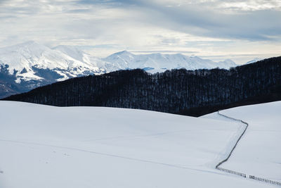 Scenic view of snowcapped mountains against sky in accumoli, lazio italy 