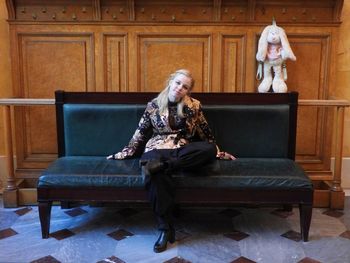 Portrait of woman sitting on sofa at home