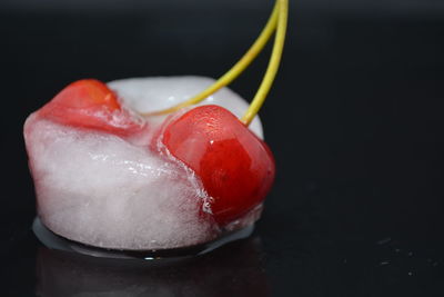 Close-up of wet strawberry over black background