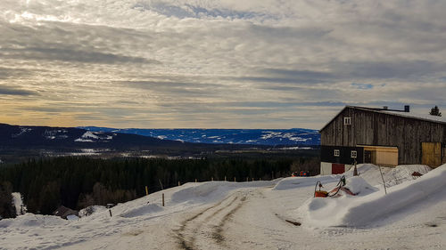 Snow covered landscape against sky