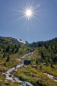 Scenic view of mountains against sky on sunny day