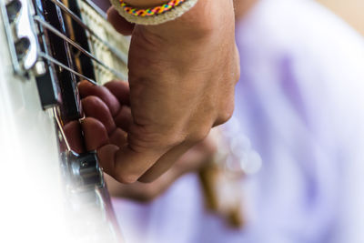 Close-up of hand playing guitar