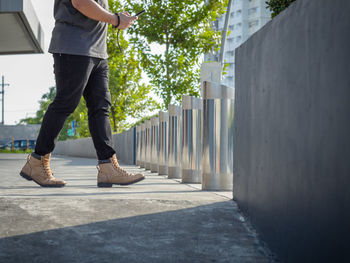 Low section of man standing on footpath