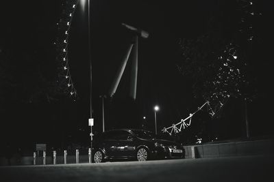 Low angle view of illuminated street lights at night