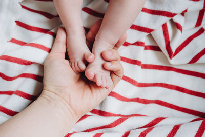 Low section of baby feet on bed