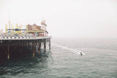 Brighton pier over sea against clear sky