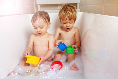 High angle view of cute baby boy in bathtub at home