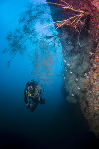 Scuba diver swimming under deep water