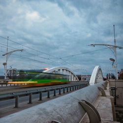 Railroad tracks against cloudy sky