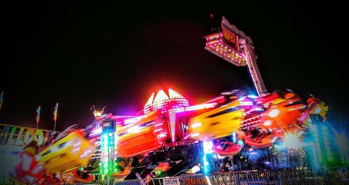 Low angle view of illuminated ferris wheel