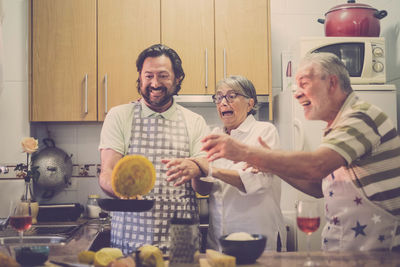 Happy family preparing food in kitchen