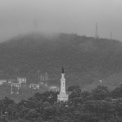 View of lighthouse and buildings against sky