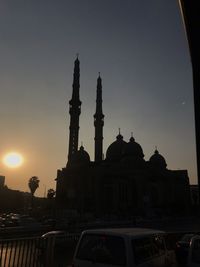 Buildings against sky during sunset in city