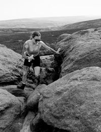 Rear view of man standing on rock