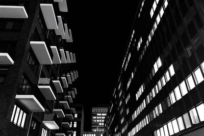 Low angle view of illuminated buildings against sky at night