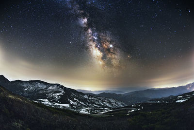 Scenic view of mountains against sky at night