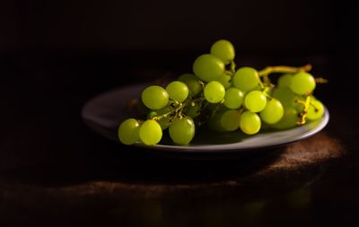 Close-up of grapes in plate on table